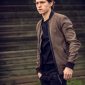 Tom Holland wearing brown cotton jacket on black ripped cuffs